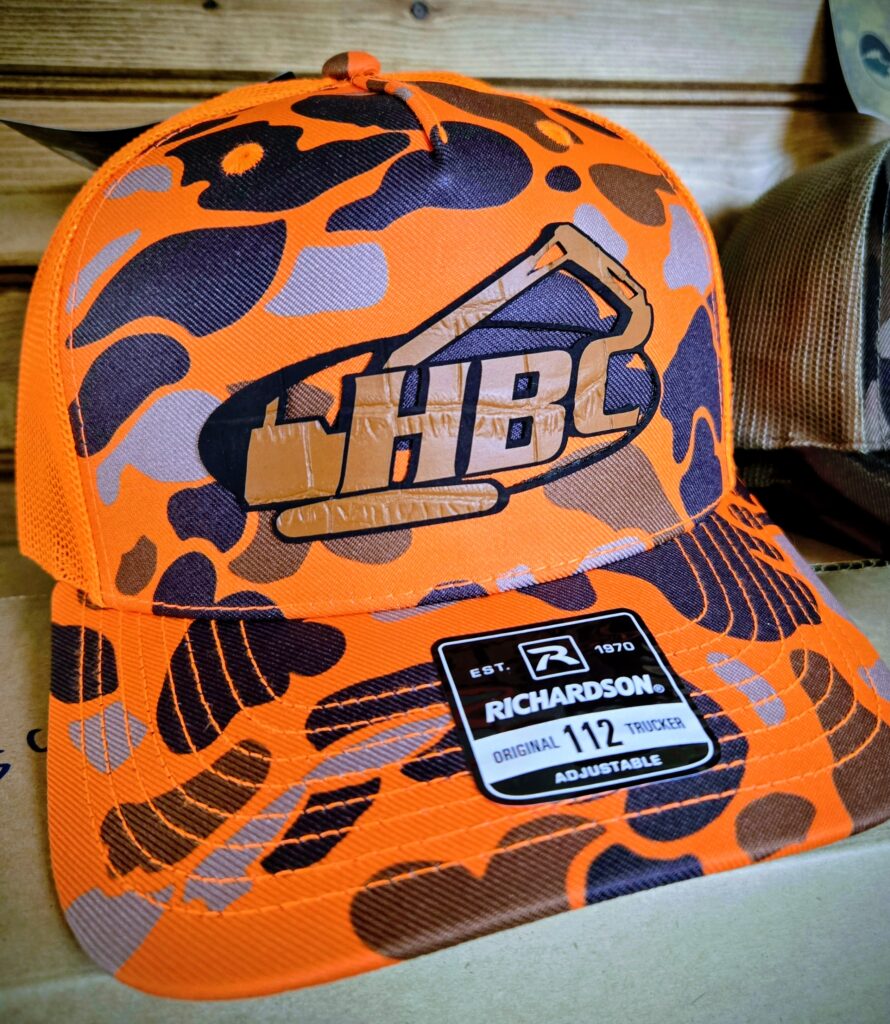 Orange and black camo-patterned HBC snapback cap.