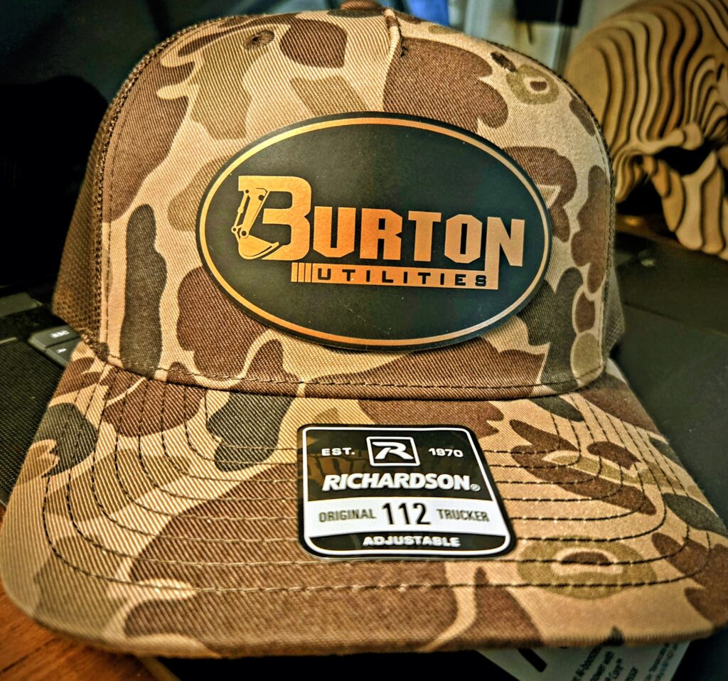 Camo Burton snowboarder cap with size tag on the brim.