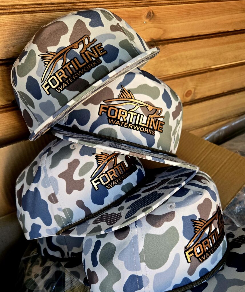 Camouflage-patterned pouches with "Tornado" branding on a wooden surface.