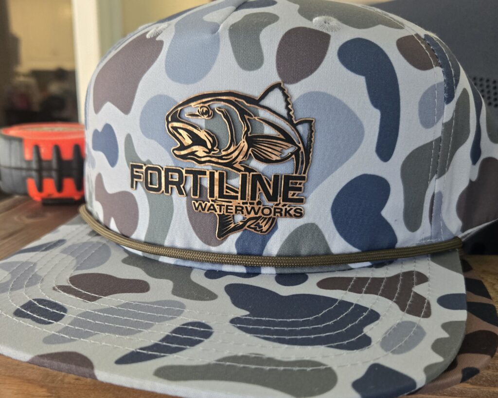 Camo-patterned hat with a fish and 'Fortline Tackle' logo.