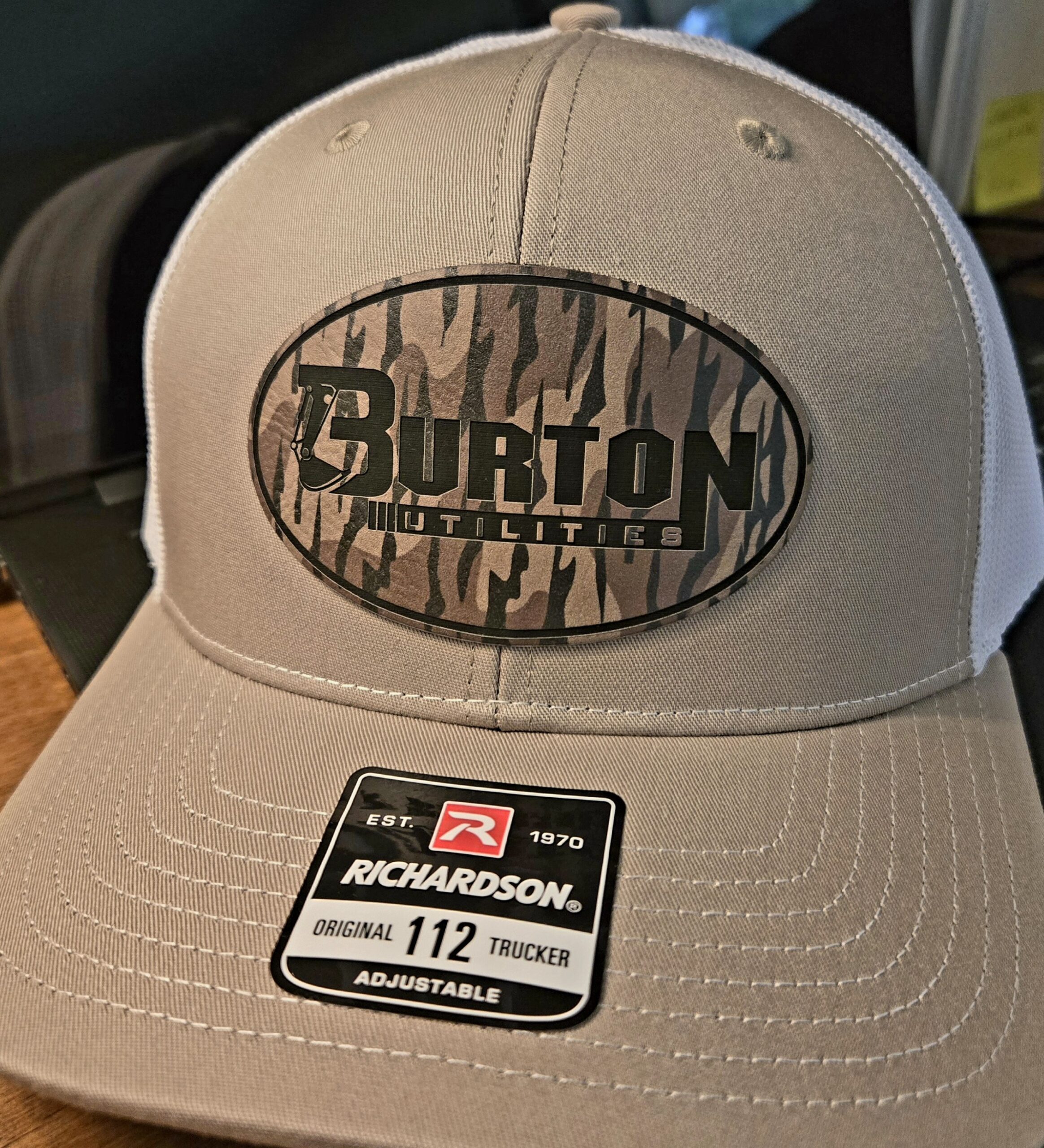 Beige Burton cap with embroidered logo and adjustable strap.