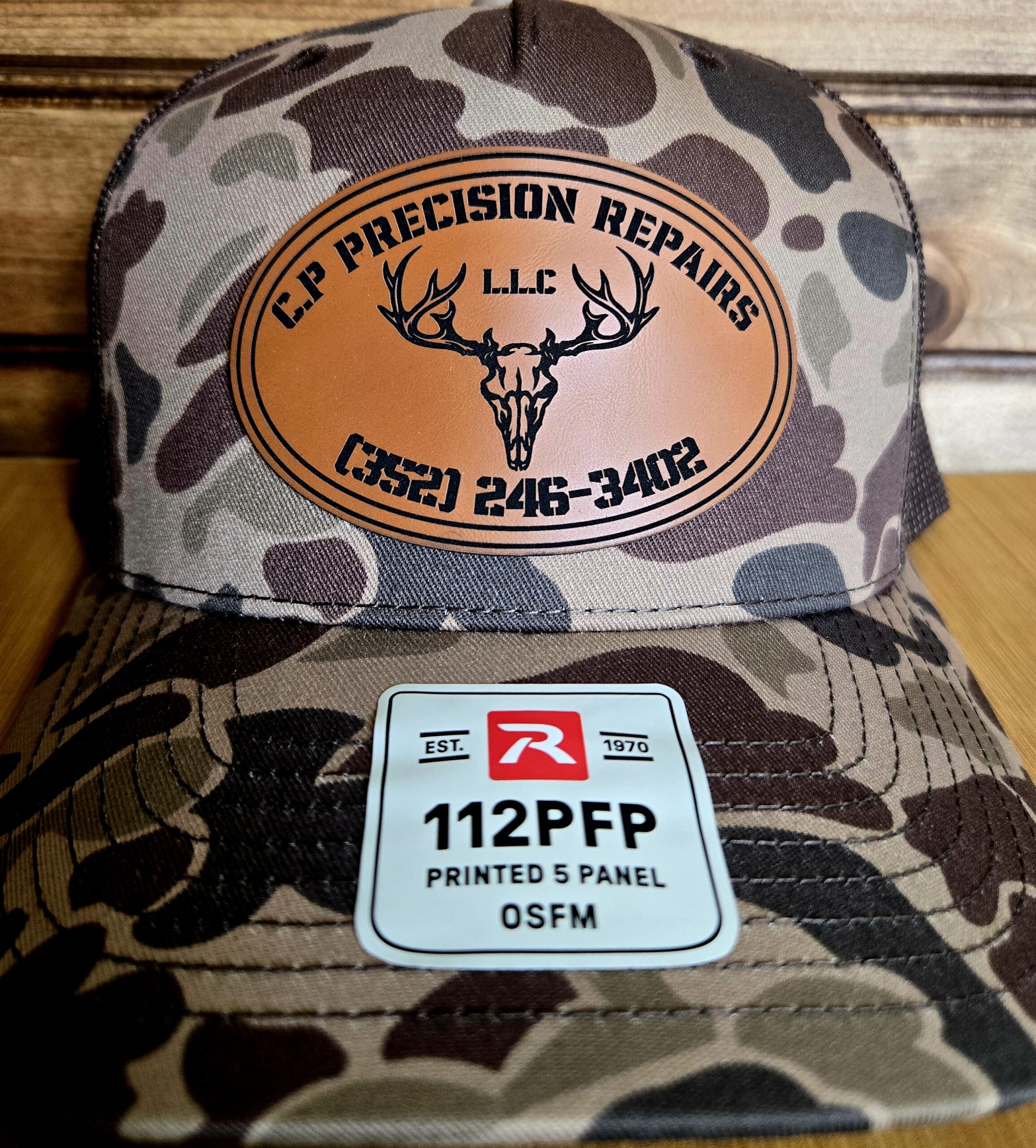 Camouflage cap with deer logo and a GSM SIM card on it.