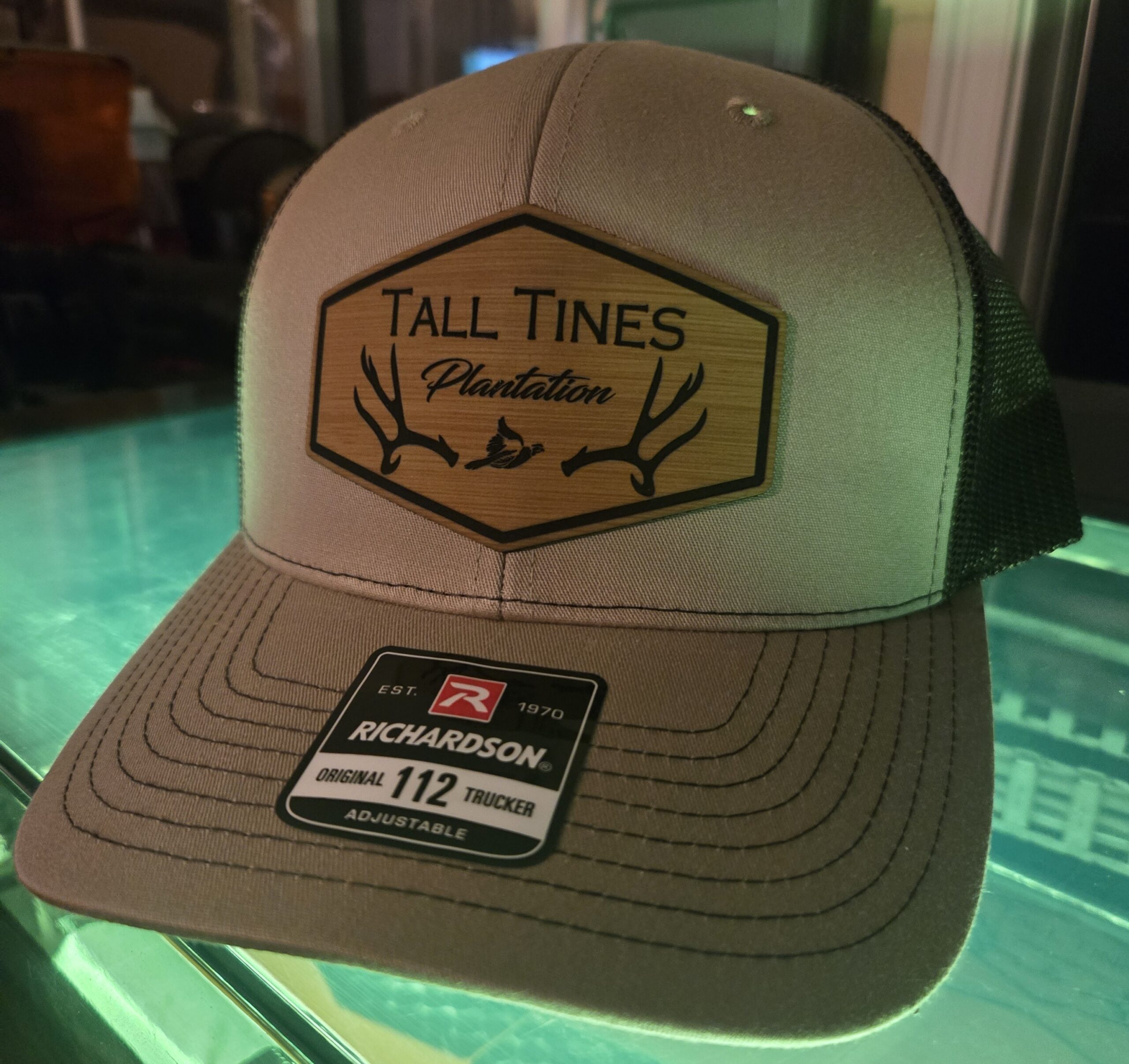 Beige Tall Tines trucker hat with a mesh back and a curved brim.
