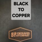 Two distinct signs, one with bold text, another with an engraved copper look.