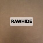 A label with the word 'RAWHIDE' on a brown surface.